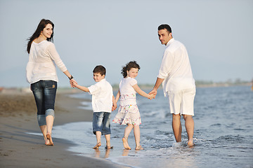 Image showing happy young family have fun on beach at sunset