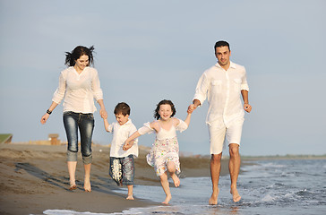 Image showing happy young family have fun on beach at sunset