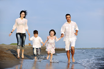 Image showing happy young family have fun on beach