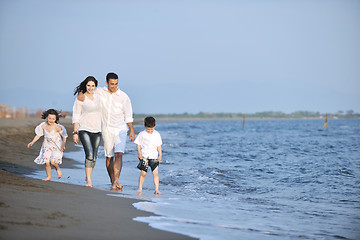 Image showing happy young family have fun on beach at sunset