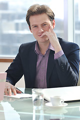 Image showing young business man alone in conference room