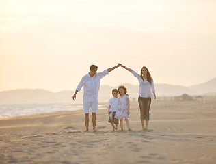 Image showing happy young family have fun on beach at sunset