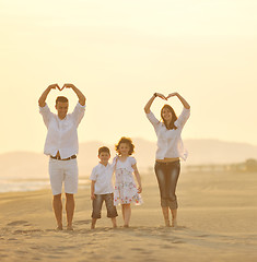 Image showing happy young family have fun on beach at sunset