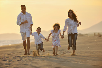 Image showing happy young family have fun on beach