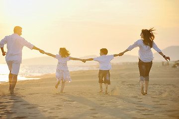 Image showing happy young family have fun on beach