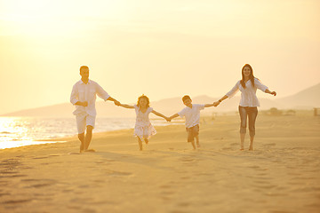 Image showing happy young family have fun on beach at sunset