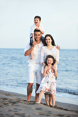 Image showing happy young family have fun on beach