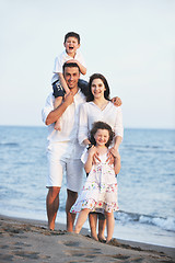 Image showing happy young family have fun on beach