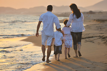 Image showing happy young family have fun on beach at sunset