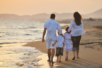 Image showing happy young family have fun on beach at sunset