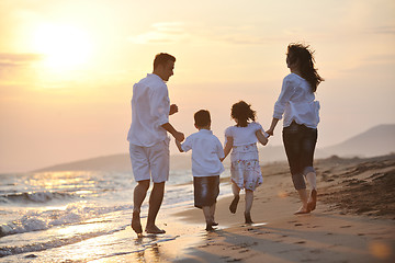 Image showing happy young family have fun on beach