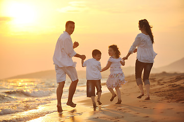 Image showing happy young family have fun on beach at sunset