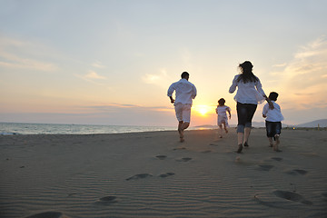 Image showing happy young family have fun on beach at sunset