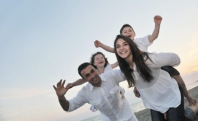 Image showing happy young family have fun on beach