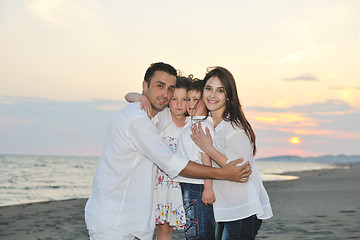 Image showing happy young family have fun on beach