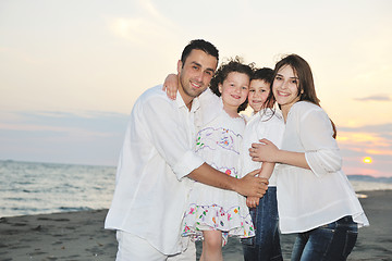 Image showing happy young family have fun on beach