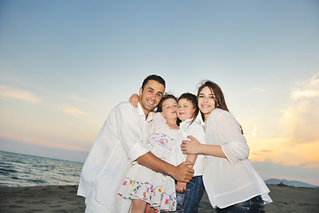 Image showing happy young family have fun on beach