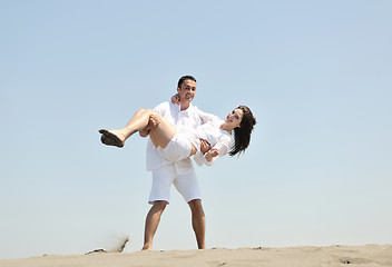 Image showing happy young couple have fun on beach