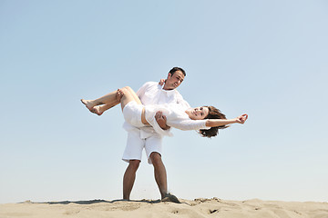 Image showing happy young couple have fun on beach