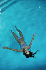 Image showing pretty young lady  relaxing in the swimming pool