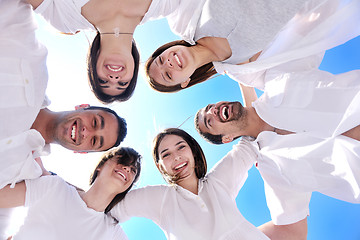 Image showing Group of happy young people in circle at beach