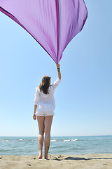 Image showing beautiful young woman on beach with scarf