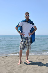 Image showing funny superhero standing on beach