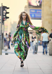 Image showing elegant woman on city street at night