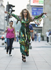 Image showing elegant woman on city street at night