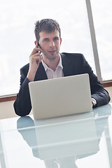 Image showing young business man alone in conference room