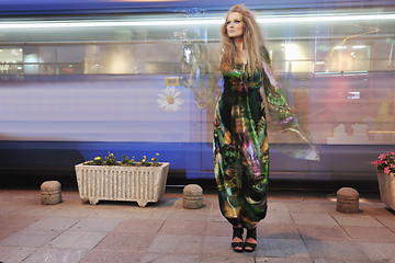 Image showing elegant woman on city street at night