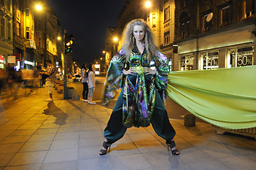 Image showing elegant woman on city street at night