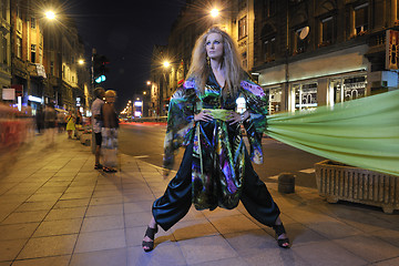 Image showing elegant woman on city street at night