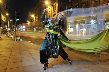 Image showing elegant woman on city street at night