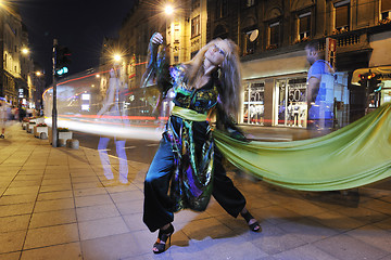 Image showing elegant woman on city street at night