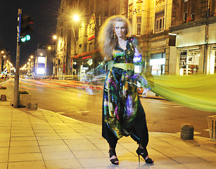 Image showing elegant woman on city street at night