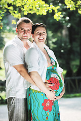 Image showing Happy pregnant couple at beautiful sunny day in park