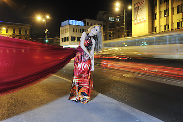 Image showing elegant woman on city street at night