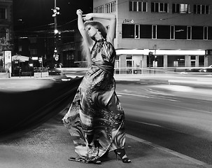 Image showing elegant woman on city street at night