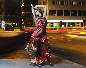 Image showing elegant woman on city street at night