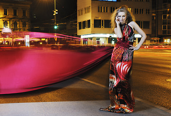 Image showing elegant woman on city street at night