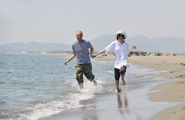 Image showing happy young couple have fun on beach