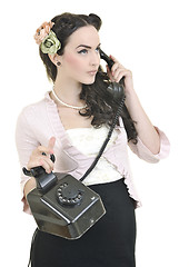 Image showing pretty girl talking on old phone