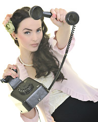 Image showing pretty girl talking on old phone