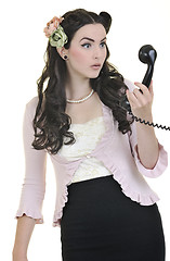 Image showing pretty girl talking on old phone