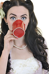 Image showing beautiful young woman with red coup of coffee isolated on white