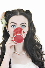 Image showing beautiful young woman with red coup of coffee isolated on white