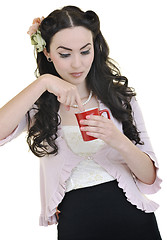 Image showing beautiful young woman with red coup of coffee isolated on white