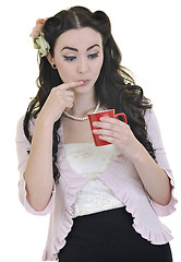 Image showing beautiful young woman with red coup of coffee isolated on white