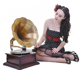 Image showing pretty girl listening music on old gramophone